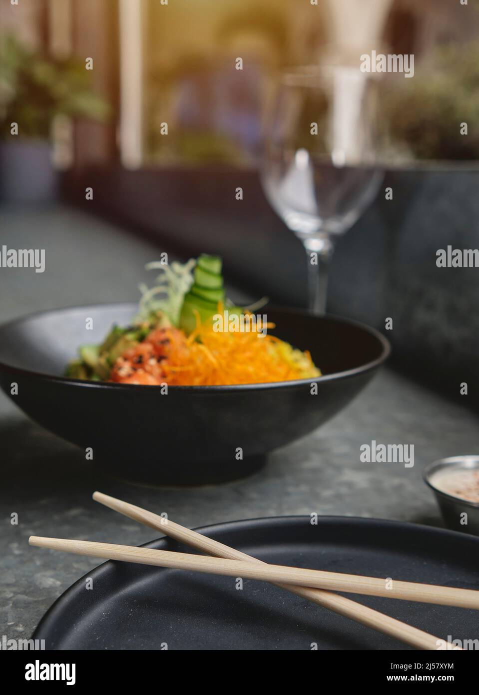 Poke bowl, traditional Hawaiian raw salmon fish salad, with chopsticks and copy space. Selective focus. Stock Photo