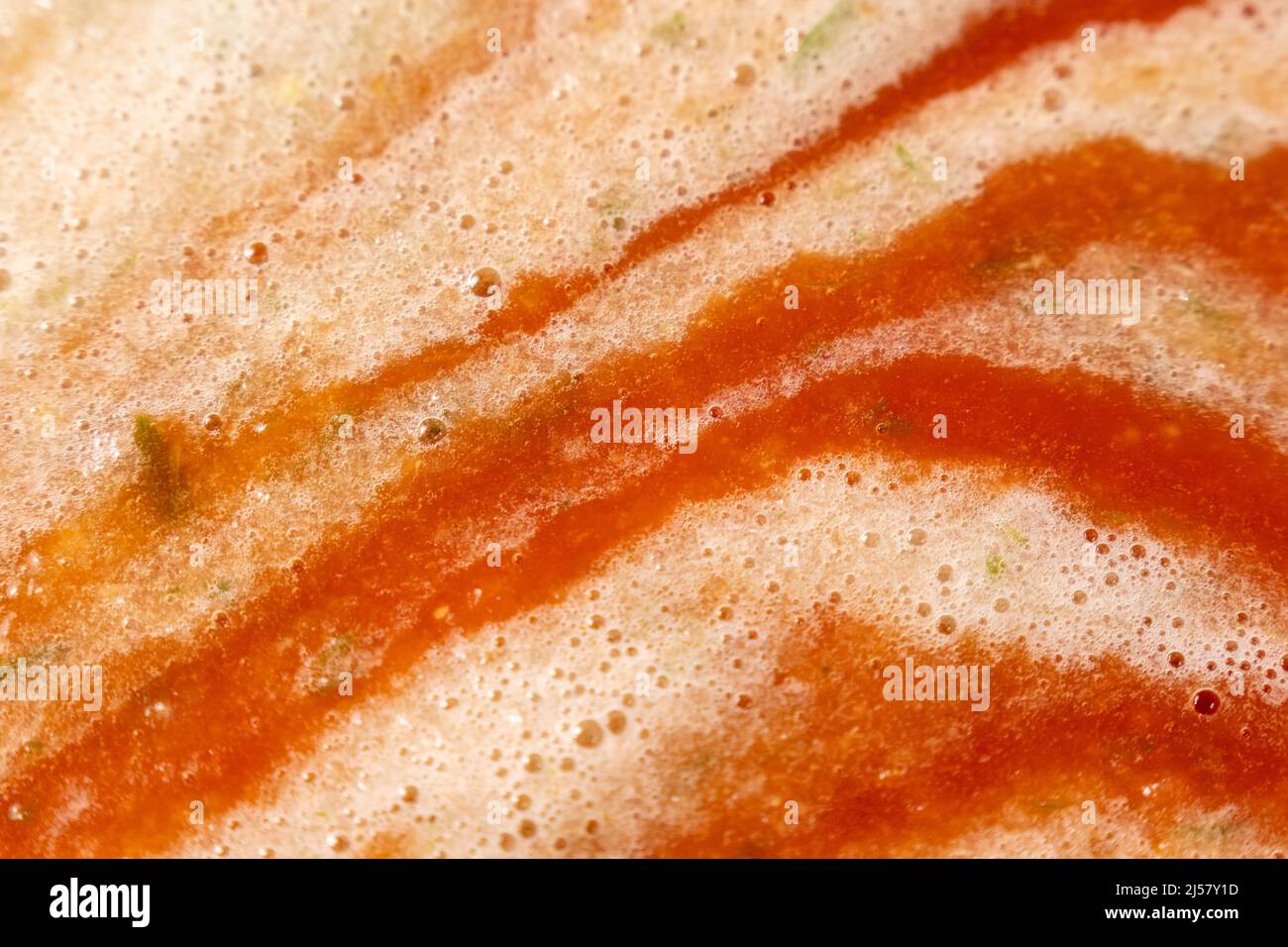Sauce of ripe tomatoes. The texture of tomato sauce. Soups and other vegetable dishes. Stock Photo