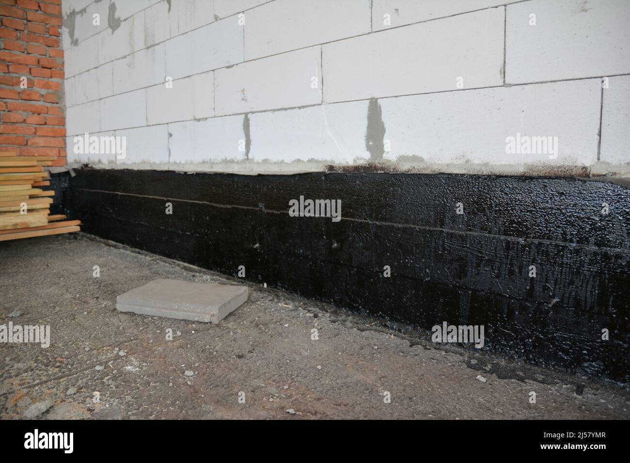 Foundation bitumen waterproofing. Building house construction with