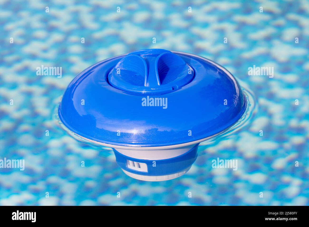 Floating dispenser in the swimming pool Stock Photo Alamy