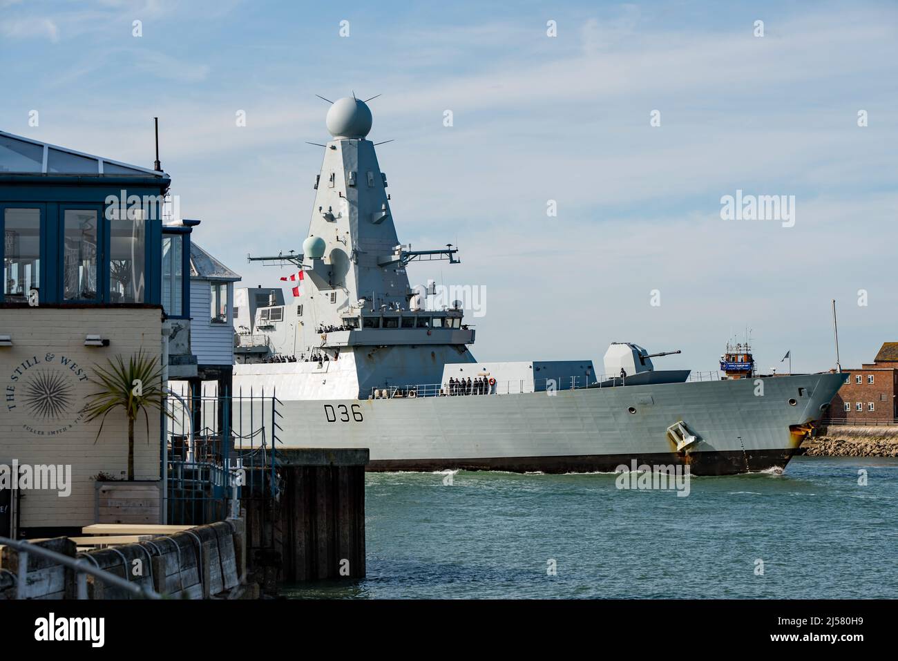 HMS Defender (D36) returned to Portsmouth, UK on 19/4/2022. The ship is seen with a painted blue nose on her bow indicating Arctic operations. Stock Photo