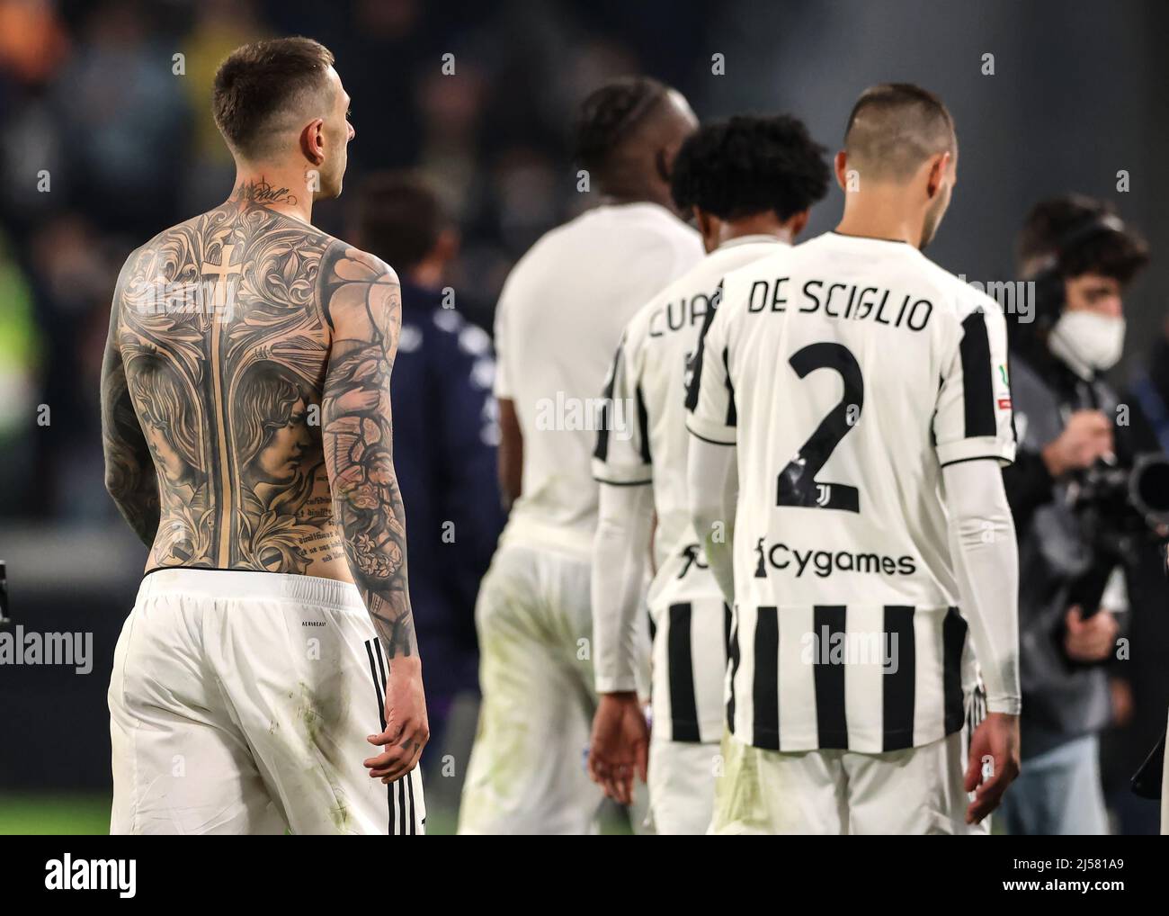 Turin, Italy, 20th April 2022. Federico Bernardeschi of Juventus leaves the field of without his jersey showing his covering his entire back following final whistle of the Coppa Italia