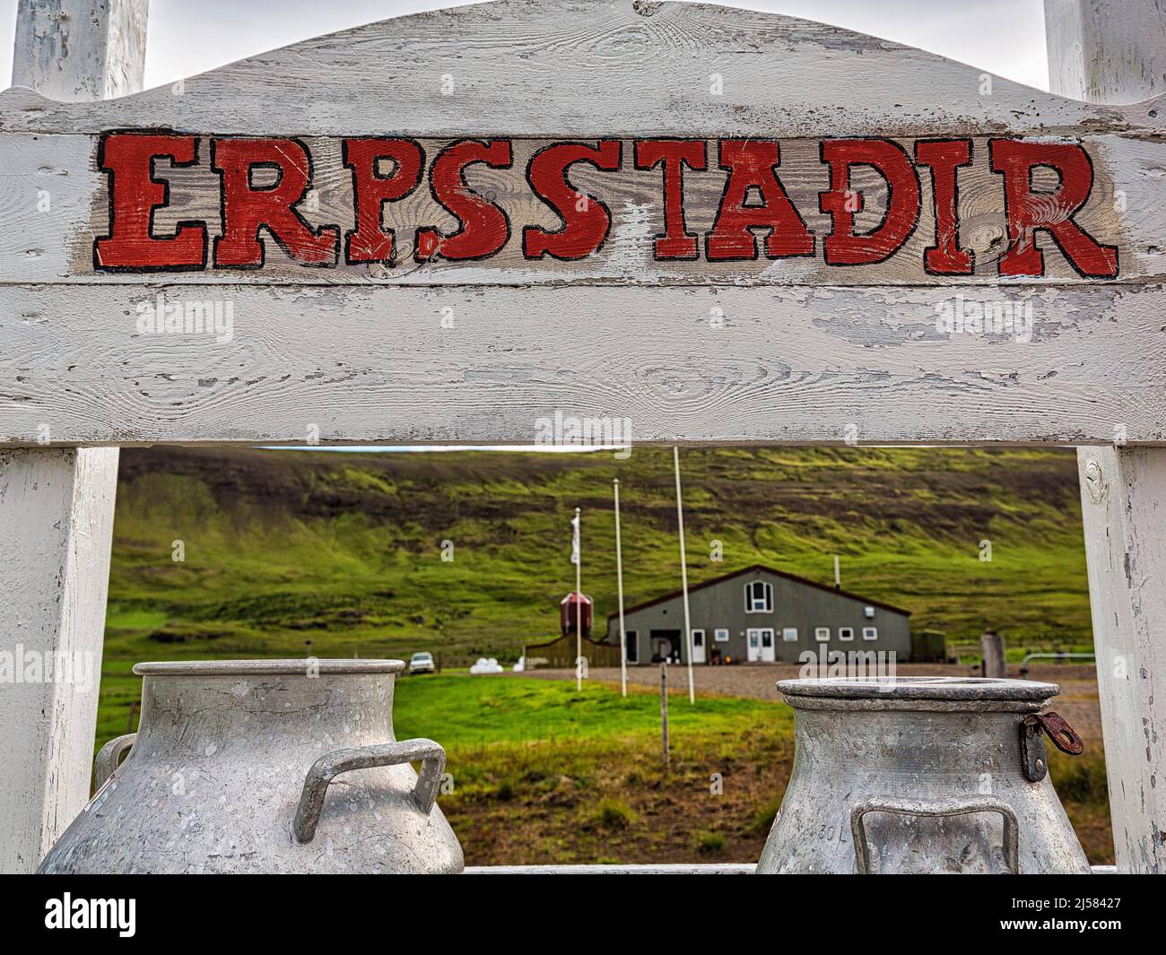 Wooden sign with the inscription Erpsstadir, Erpsstaoir, milk cans with a view of the farm, dairy for ice cream, skyr, cheese, Buoardalur Stock Photo