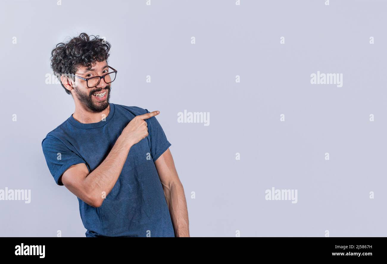 Handsome man pointing to the side, smiling guy pointing his fingers to