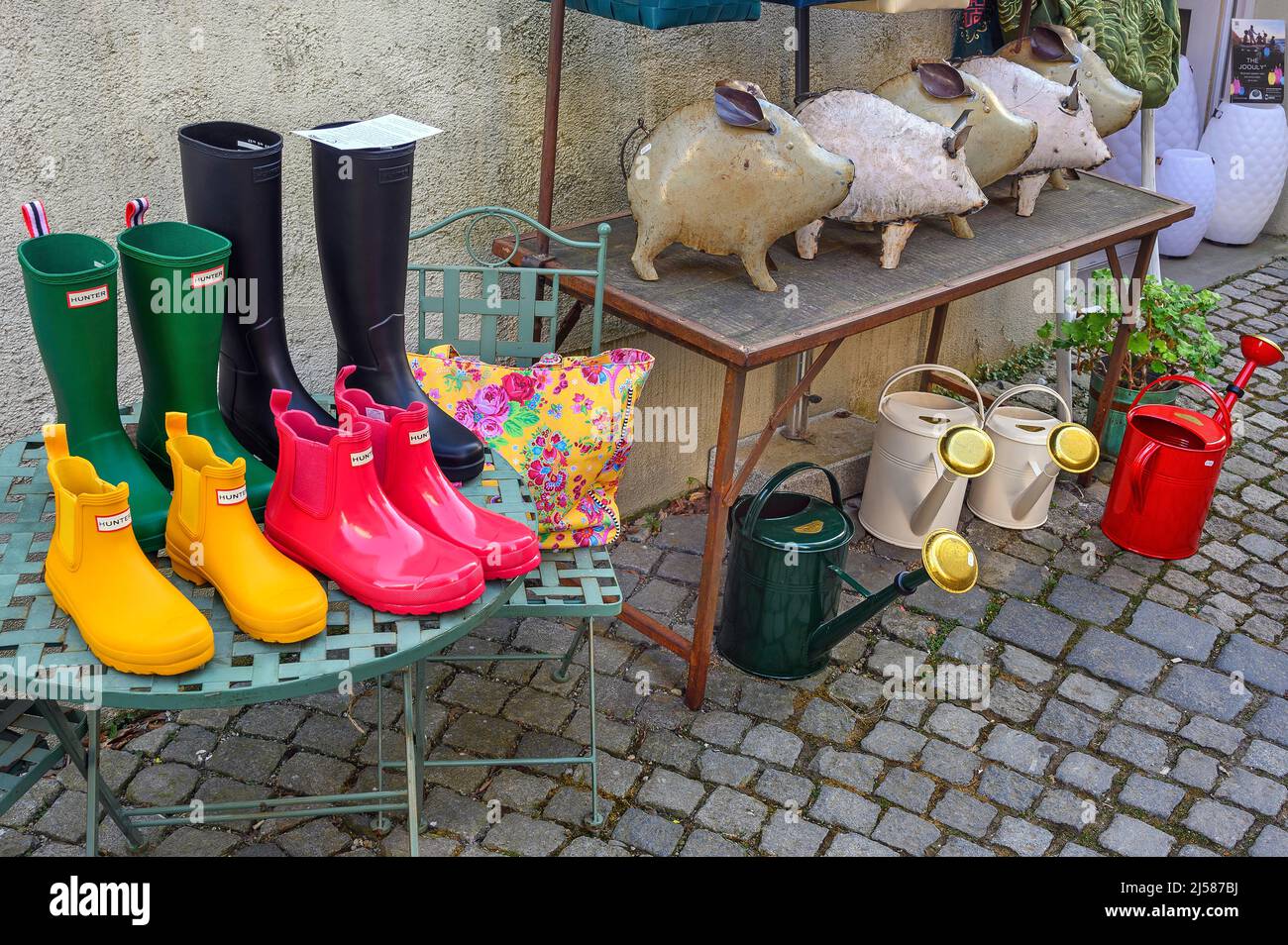 Tin pigs, colourful boots and watering cans, Lindau, Swabia, Bavaria, Germany Stock Photo