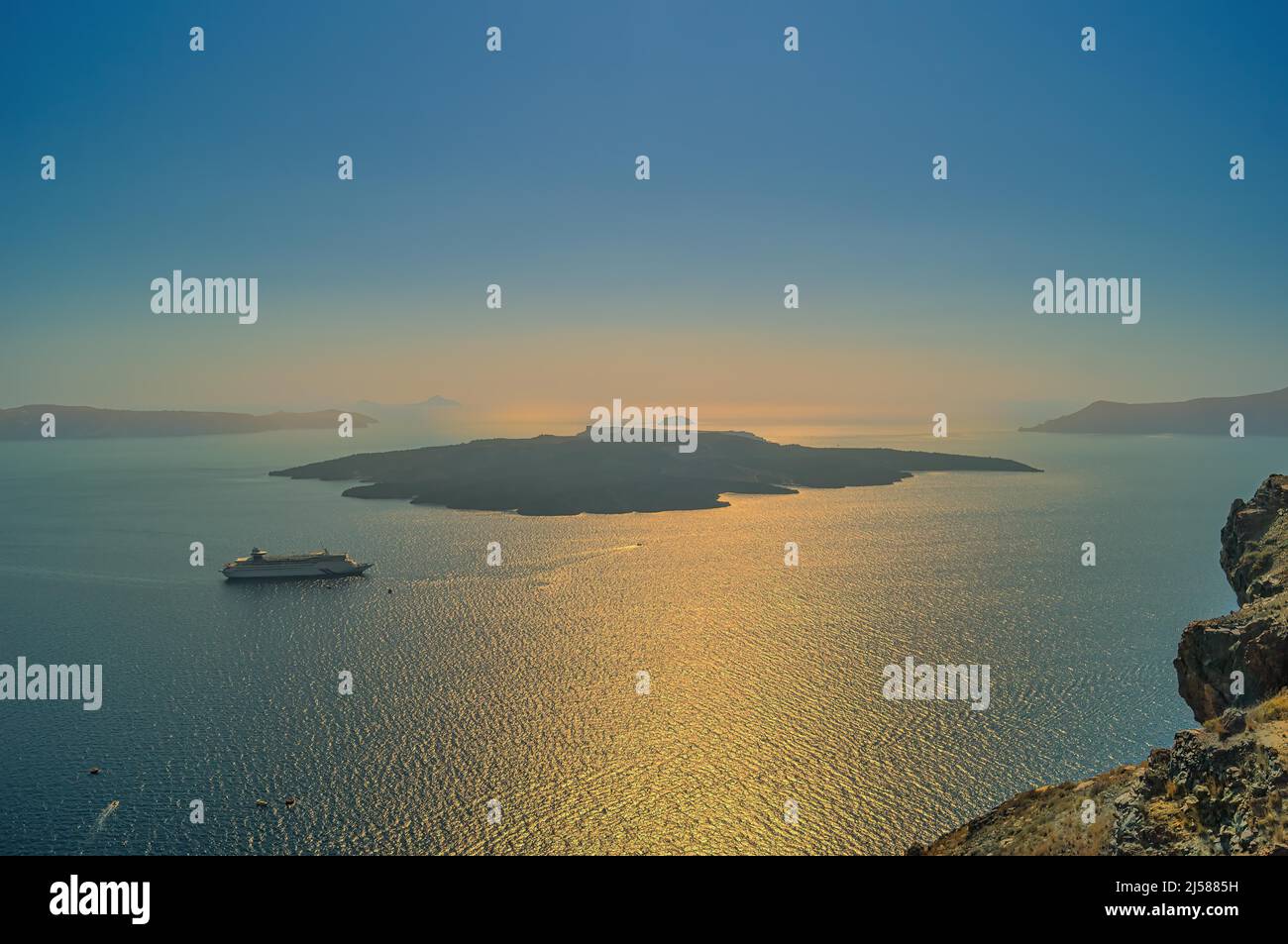 View over the Caldera with cruise ship at sunset, Santorini, Greece Stock Photo