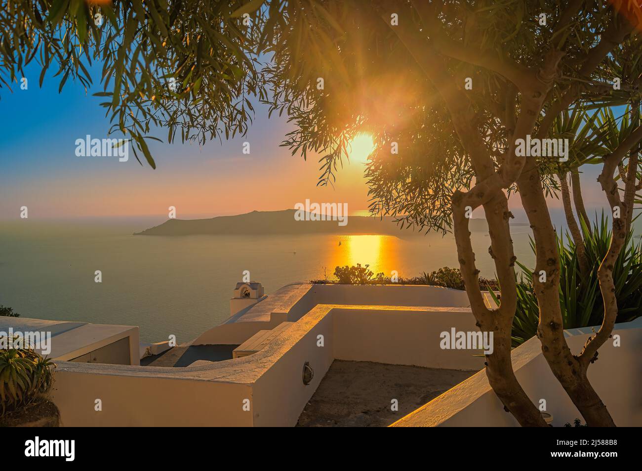 Romantic sunset with backlit view over the sea, Santorini, Greece Stock Photo