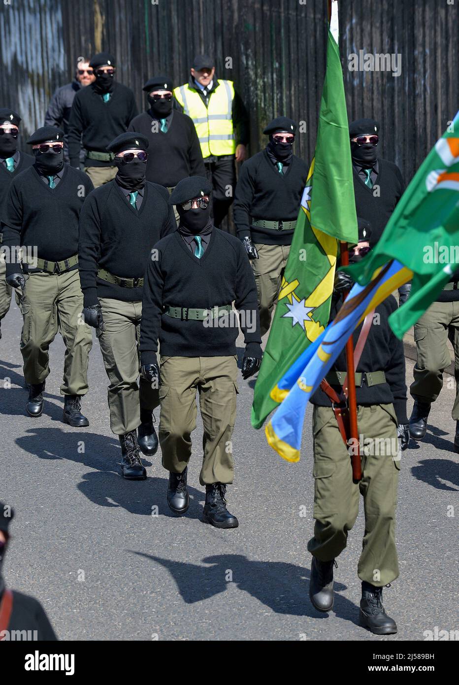 Masked men and women in paramilitary uniform at an Easter Monday Dissident Republican parade in Derry, Northern Ireland 18 March 2022. ©George Sweeney / Alamy Stock Photo Stock Photo