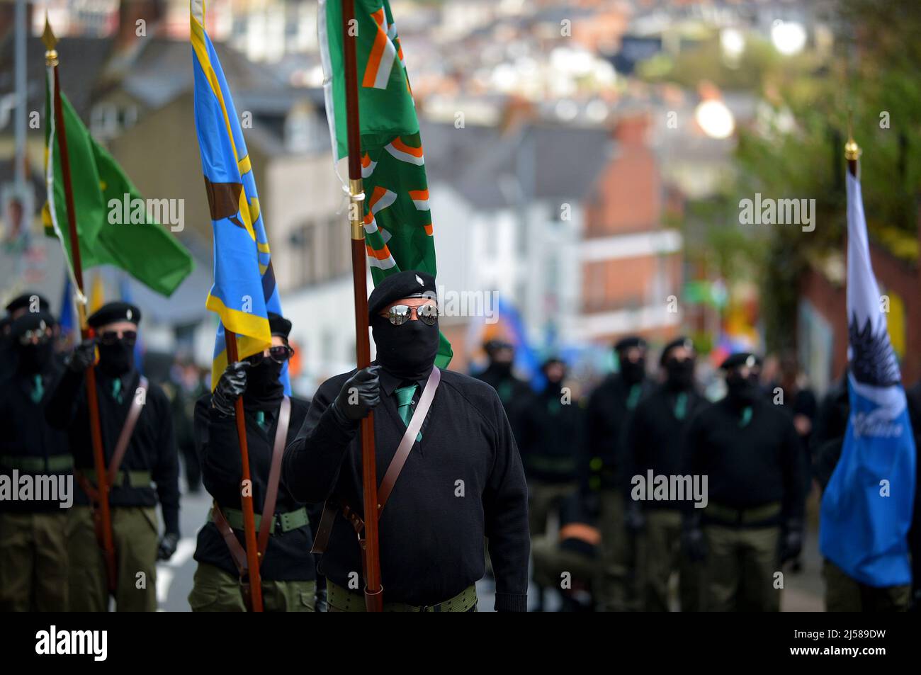 Masked men and women in paramilitary uniform at an Easter Monday Dissident Republican parade in Derry, Northern Ireland 18 March 2022. ©George Sweeney / Alamy Stock Photo Stock Photo