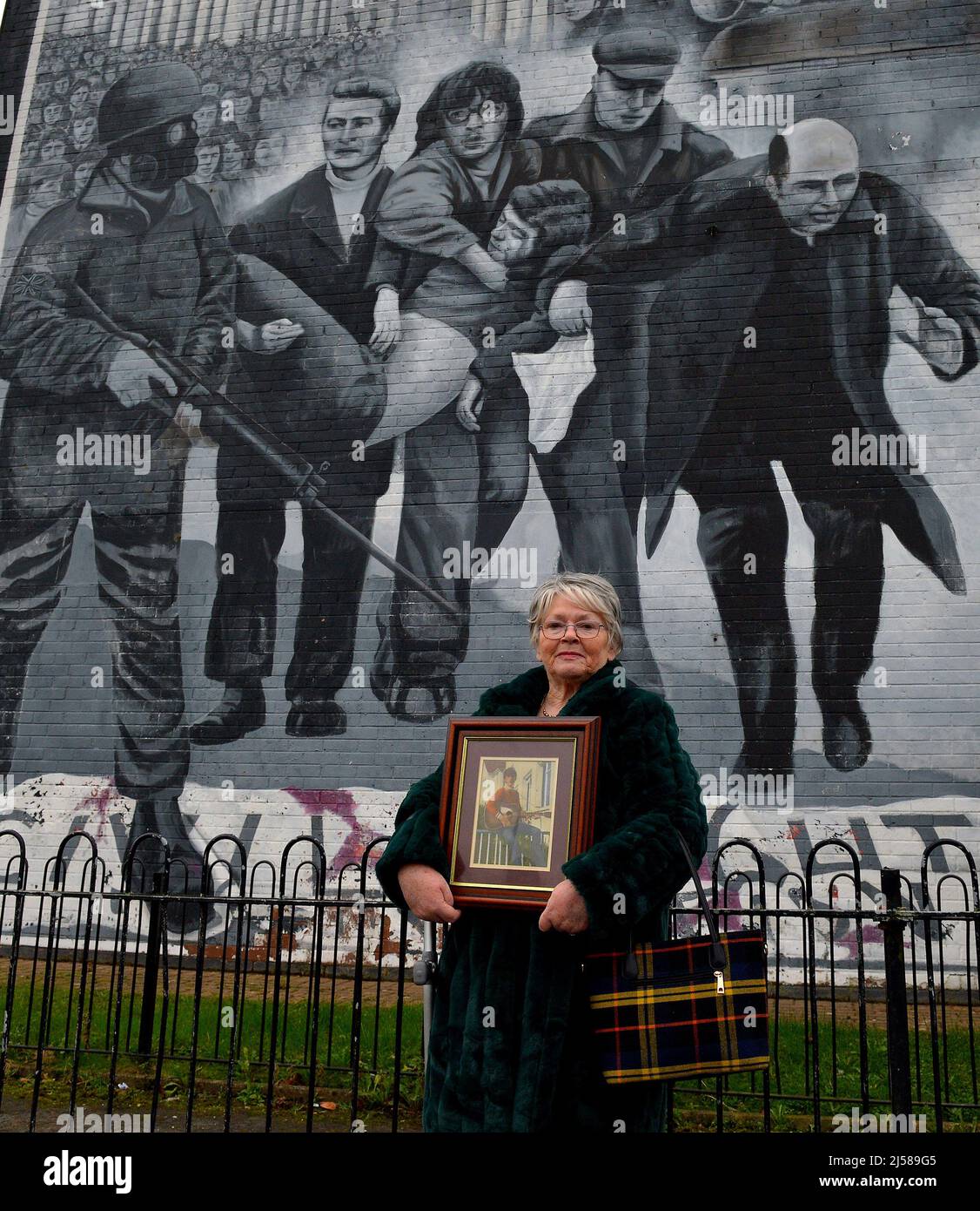 Kate Nash, at the Bloody Sunday Mural in the Bogside, whose brother William was killed and whose father Alex was seriously injured, by British Paratroopers, on Bloody Sunday1972 in Derry, Northern Ireland, ©George Sweeney / Alamy Stock Photo Stock Photo