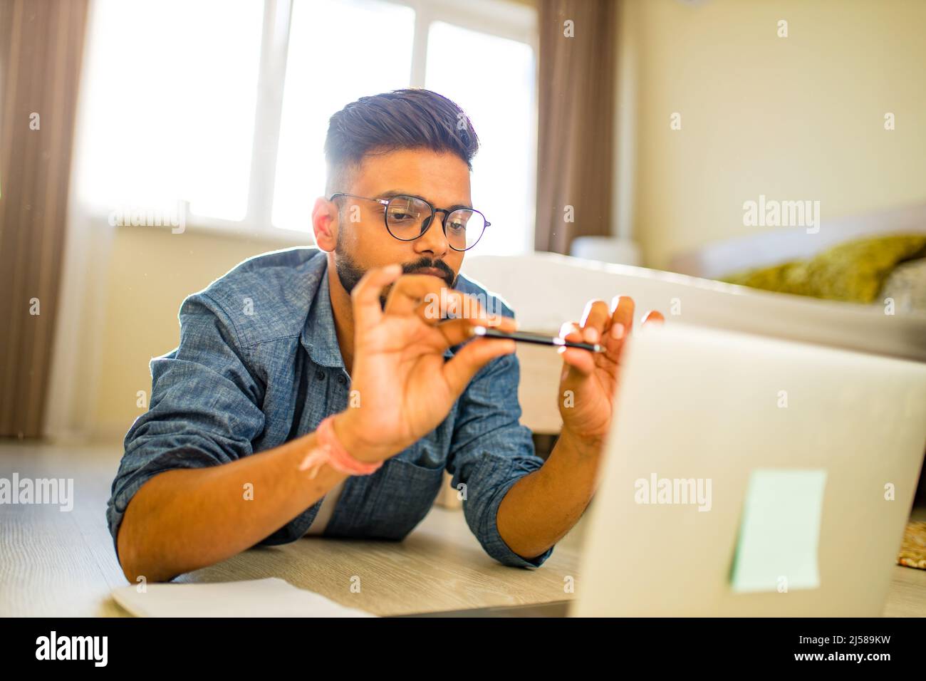 indian man training education and freelance work in new apartment Stock Photo