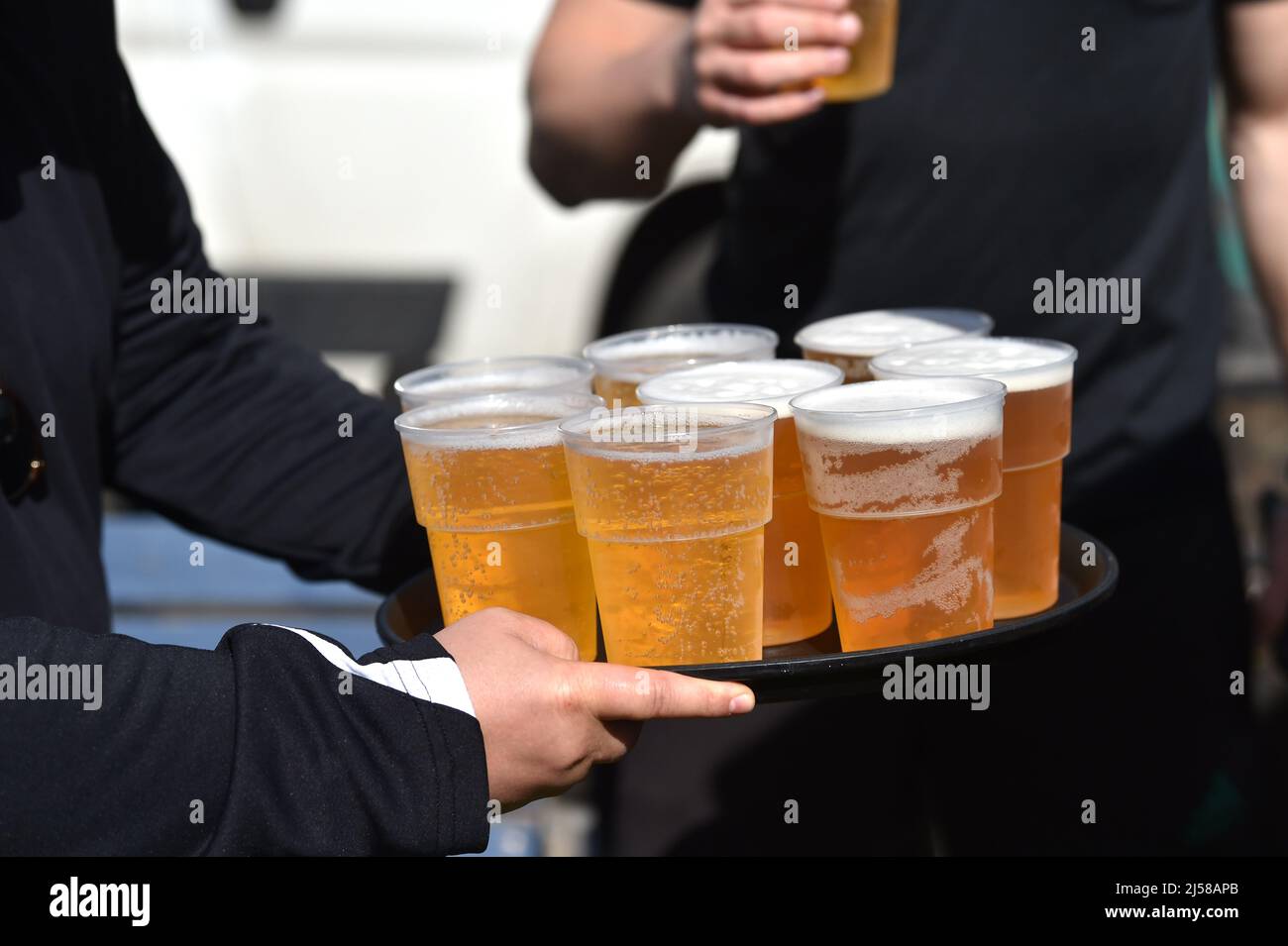 Man carrying a tray of lager beer UK Stock Photo