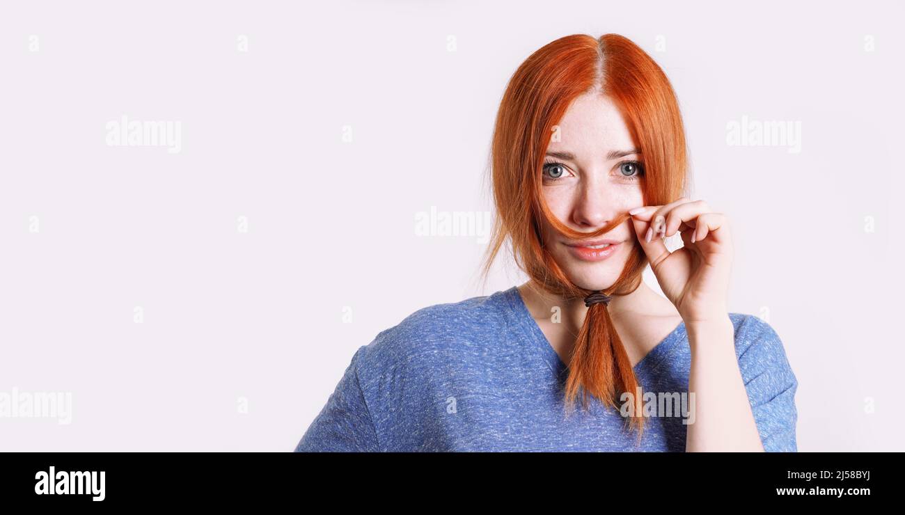 playful woman in disguise with hair tied to long beard Stock Photo