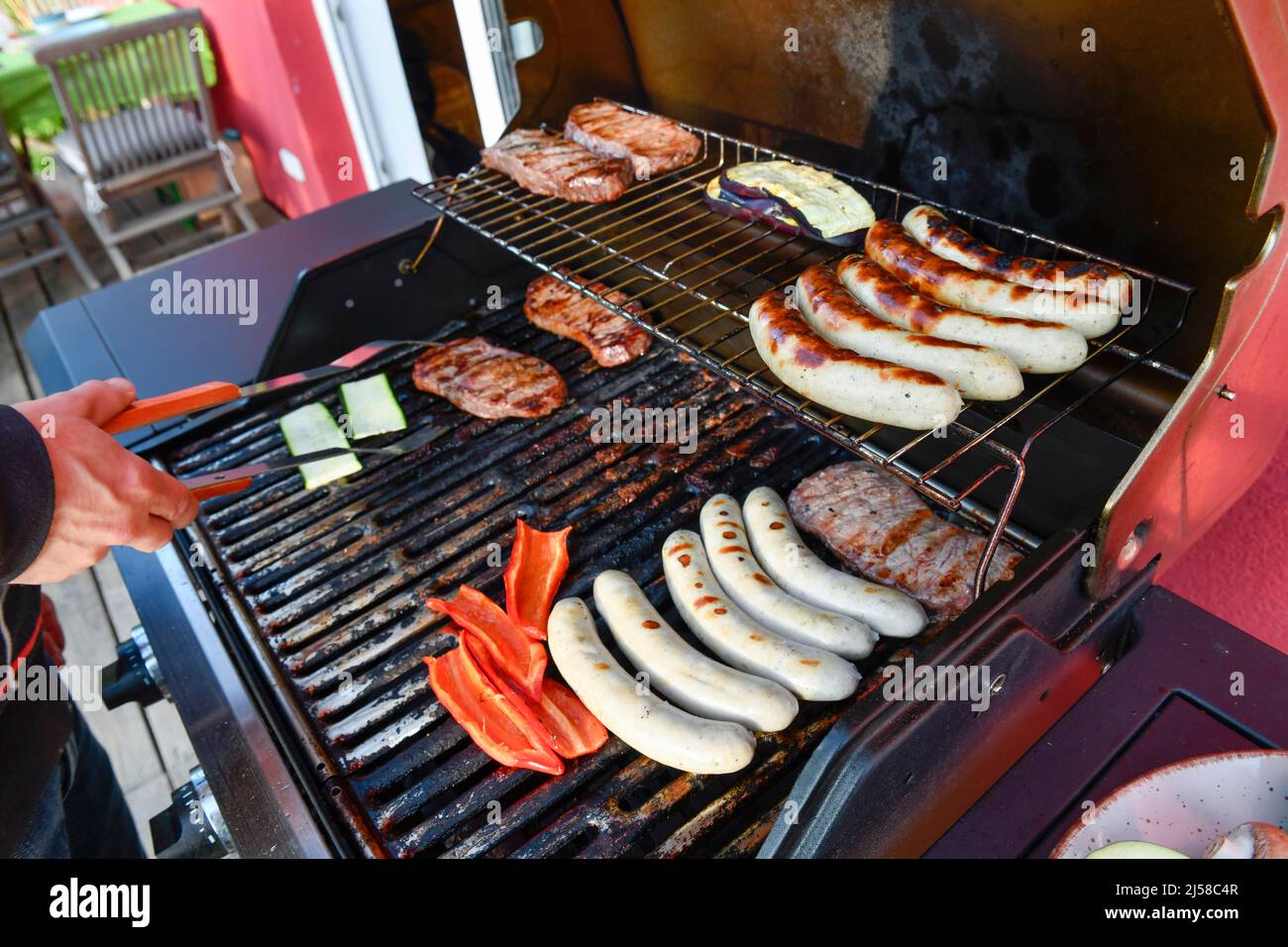 Sausages, steaks, gas grill Stock Photo Alamy