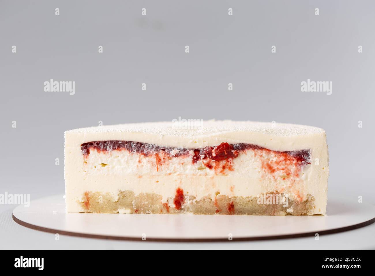 On a white background, a sweet pastry cake is cut in half, the cake is