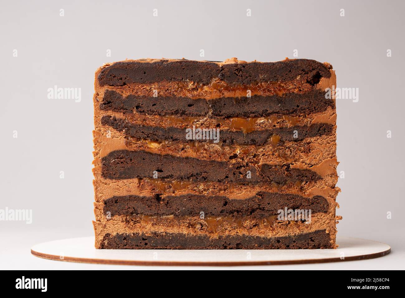 On a white background, a sweet pastry cake is cut in half, the cake is