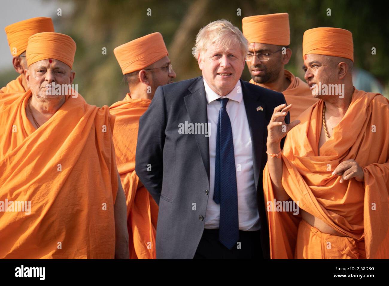 Prime Minister Boris Johnson poses for a photo with sadhus, Hindu holymen, as he visits the Swaminarayan Akshardham temple in Gandhinagar, Ahmedabad, as part of his two day trip to India. Picture date: Thursday April 21, 2022. Stock Photo