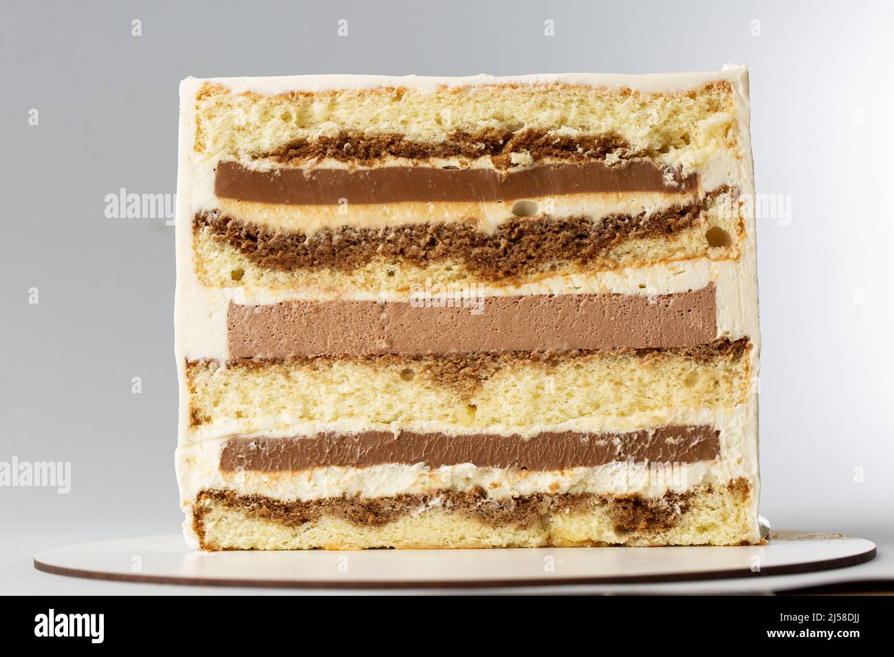 On a white background, a sweet pastry cake is cut in half, the cake is