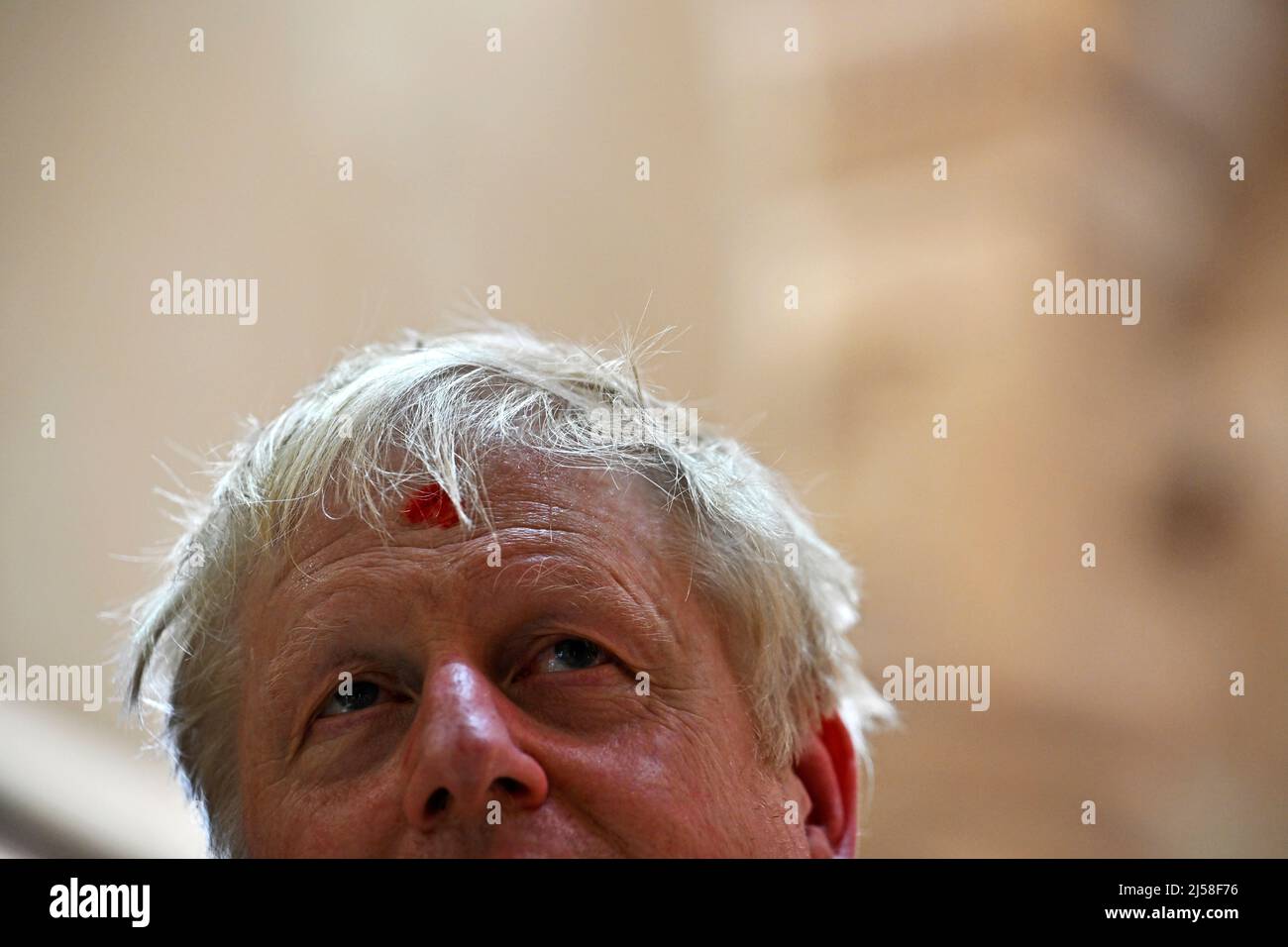 Prime Minister Boris Johnson looks on with his forehead marked by a traditional 'tilak' as he visits the Swaminarayan Akshardham temple in Gandhinagar, Ahmedabad, as part of his two day trip to India. Picture date: Thursday April 21, 2022. Stock Photo