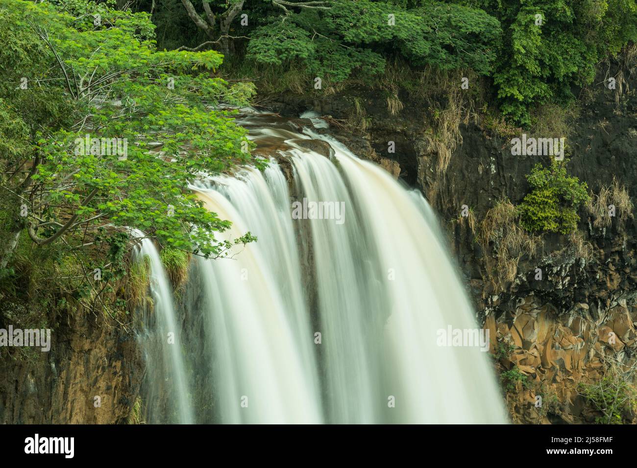 Wailua Falls on the island of Kauai in Hawaii, United States.  A slow shutter speed was used to give the water a silky look. Stock Photo