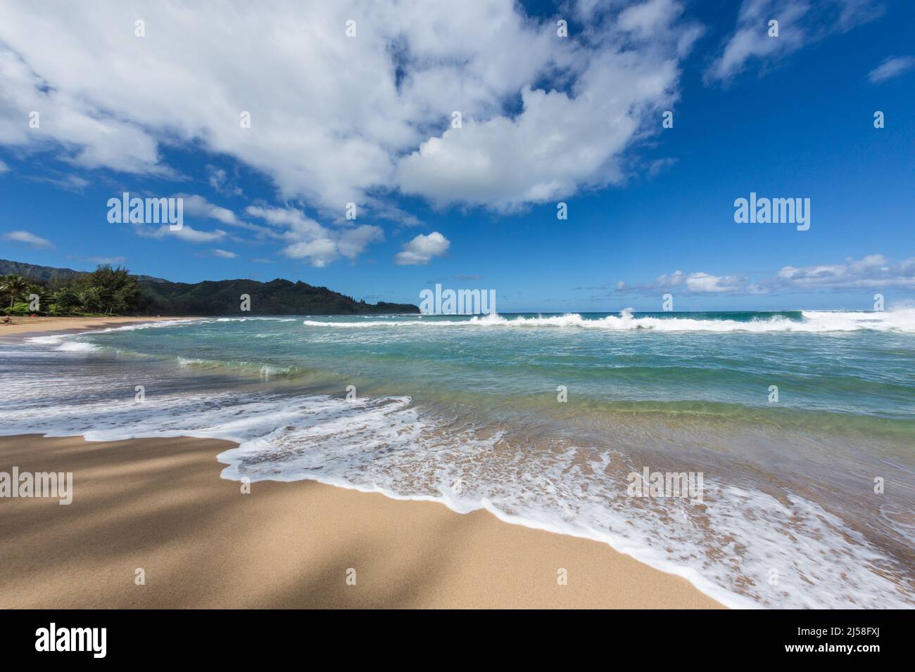 Waves and surf on Hanalei Beach on the Island of Kauai, Hawaii, United States.  Photographed with a fisheye lens which creates a distorted image. Stock Photo