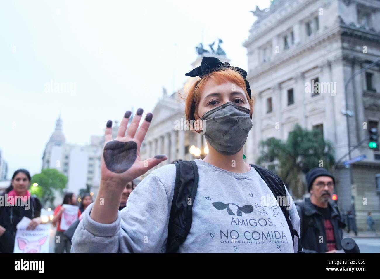 Buenos Aires, Argentina; Nov 1, 2021: World Vegan Day, activists marching in front of Congress. Young woman with her hand painted like an animal paw a Stock Photo