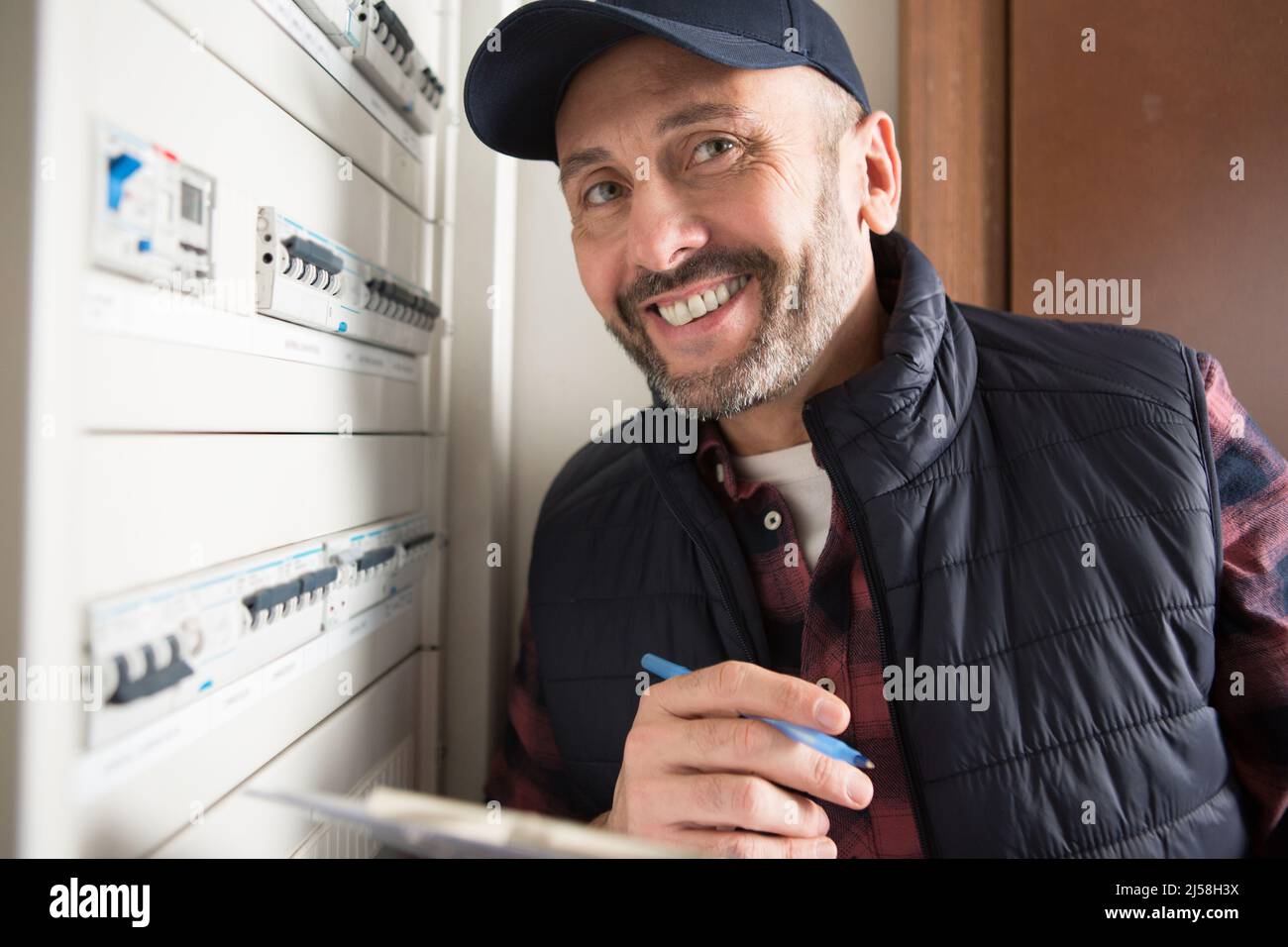portrait of electrical inspector stood by circuit breaker Stock