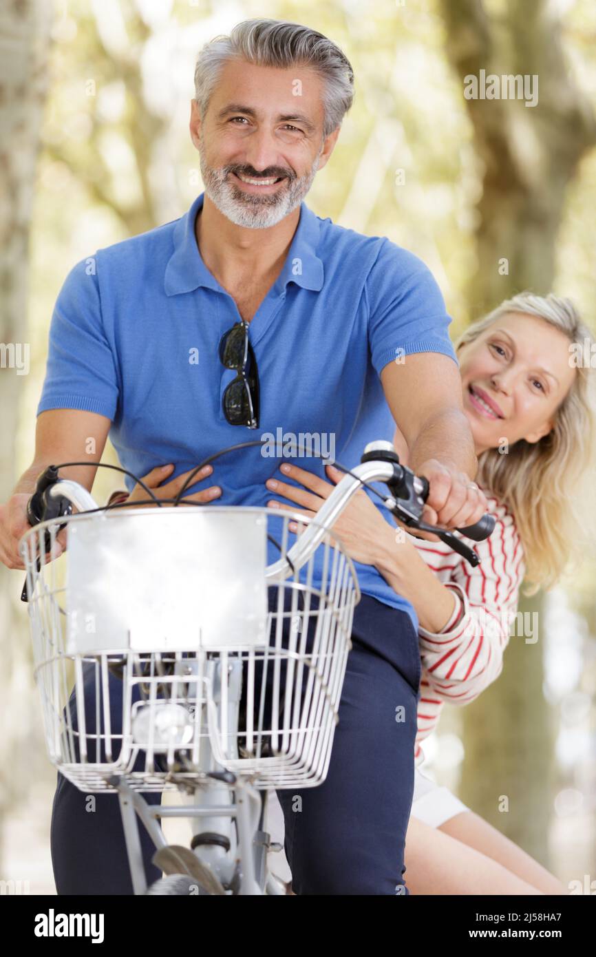 active older couple on bicycle in the park Stock Photo