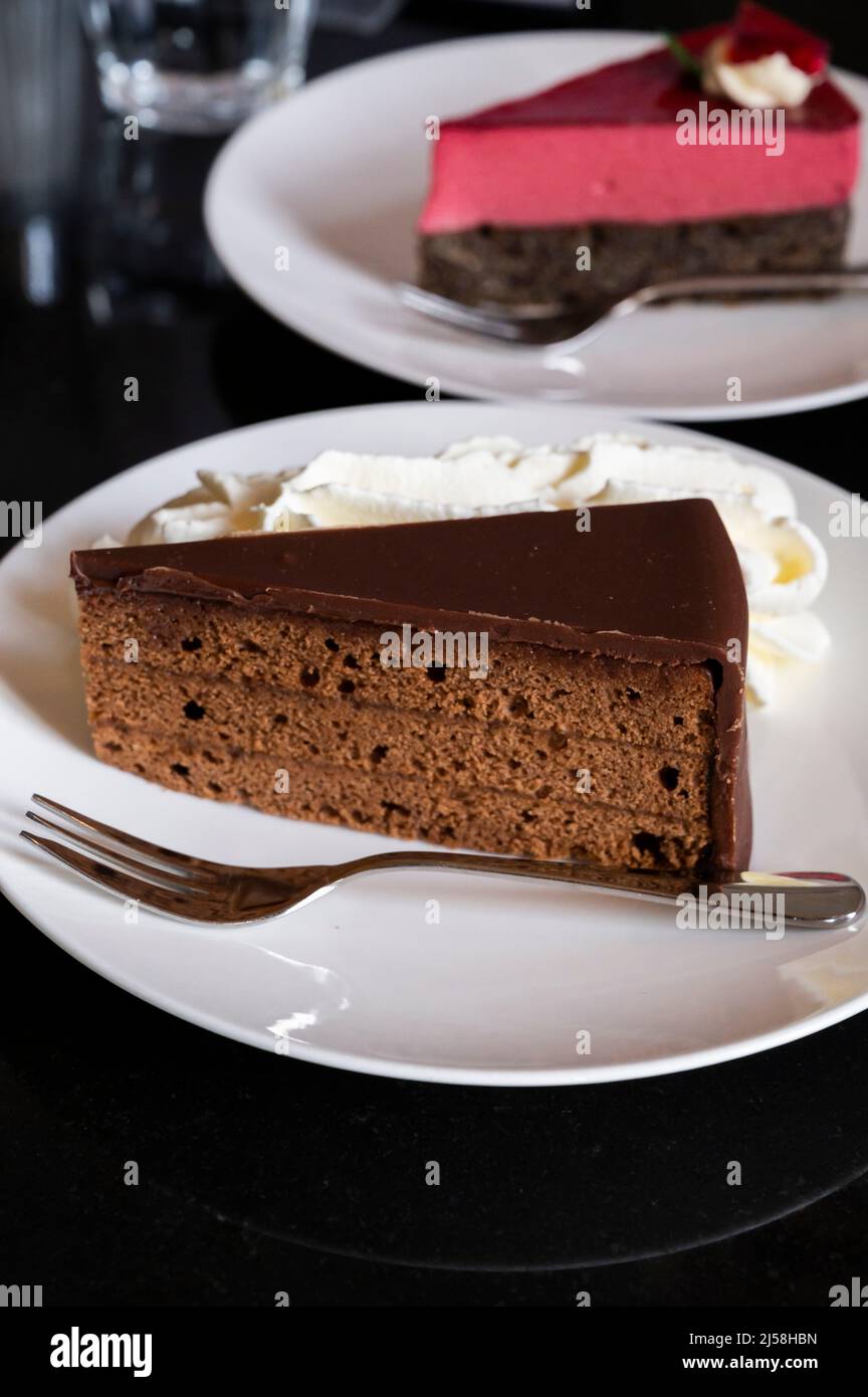 Piece of famous Sachertorte chocolate cake with apricot jam and Poppy ...