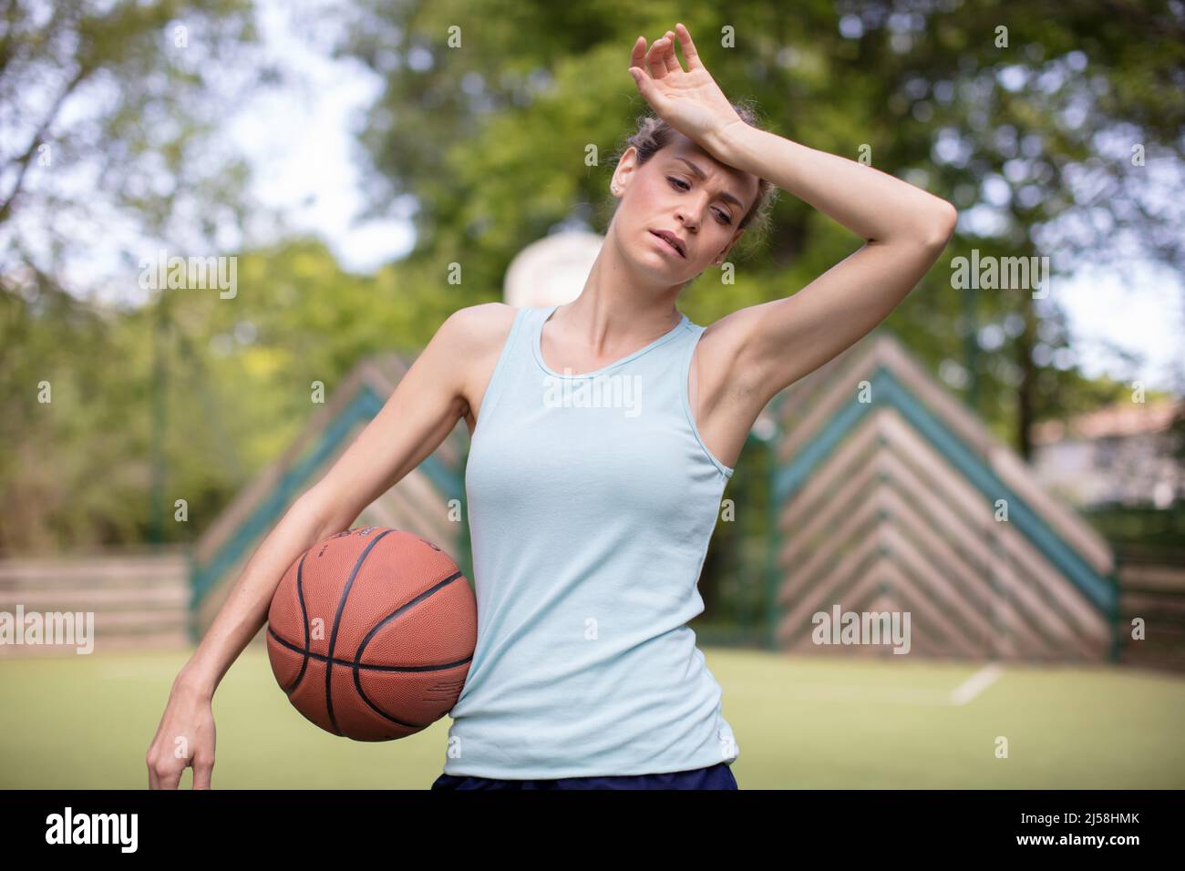 tired young woman after playing basketball Stock Photo Alamy