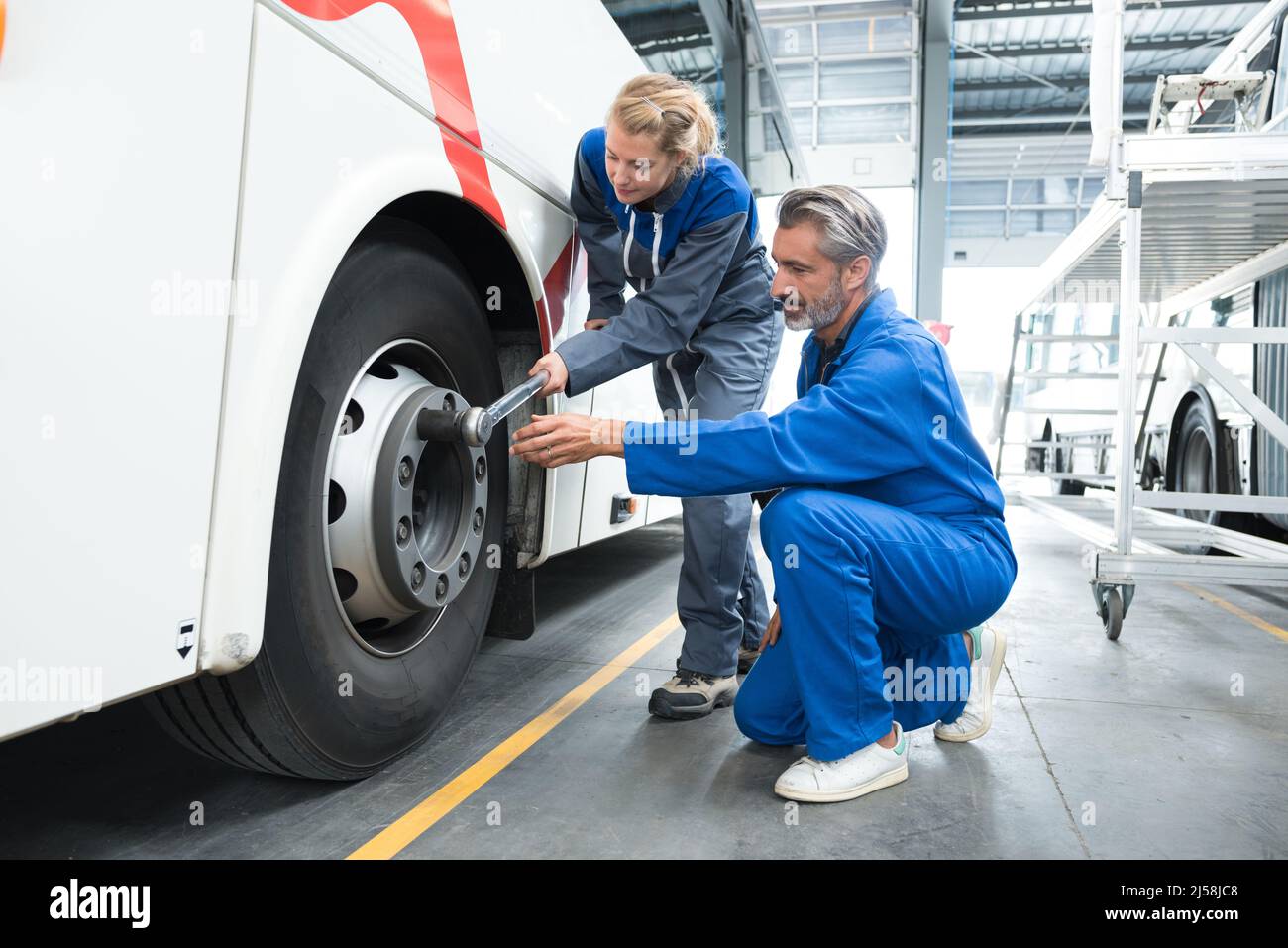 Female And Male Mechanic Working On Bus Stock Photo Alamy female-and-male-mechanic-working-on-bus-stock-photo-alamy