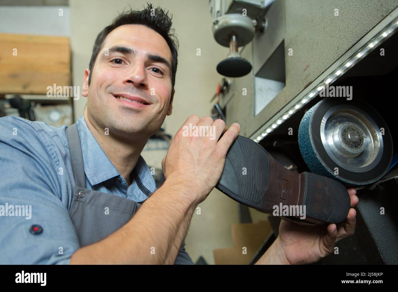 male cobbler polishing a shoe sole Stock Photo Alamy
