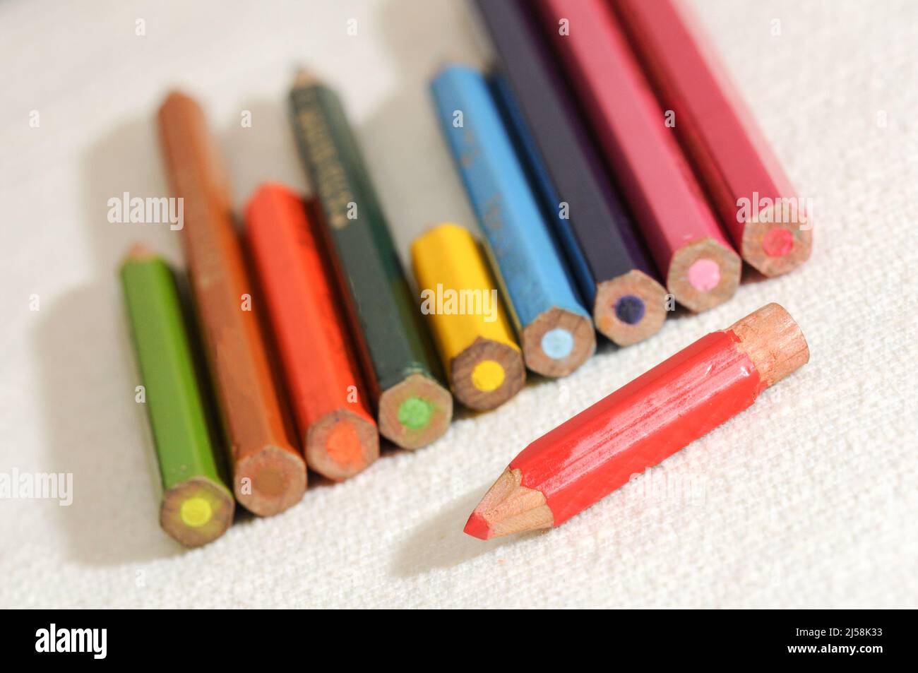 Colorful and funny arrangement of a set of pencils and ink pots. Stock Photo