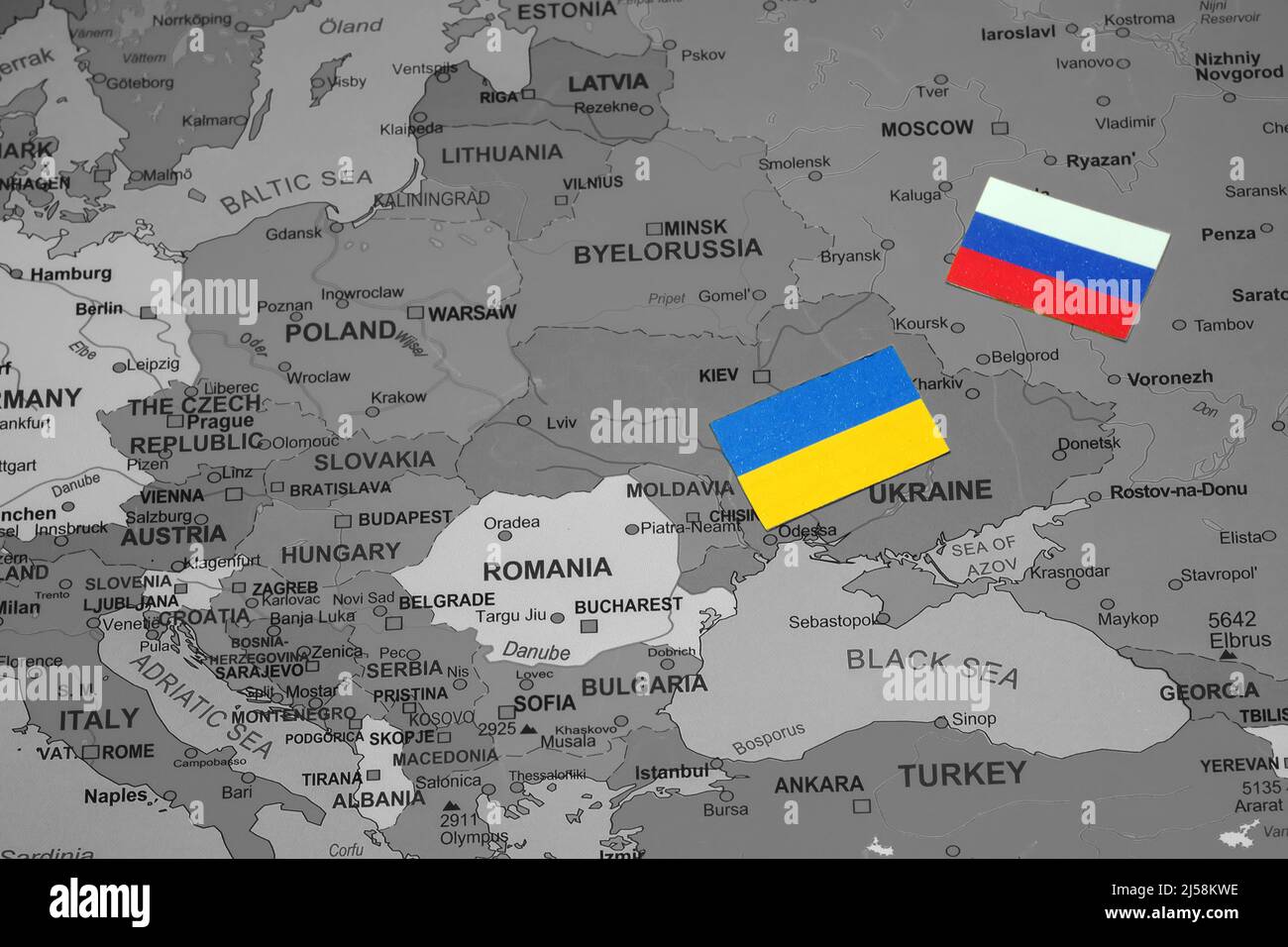 Ukrainian and Russian flags on the map of Europe. Stock Photo
