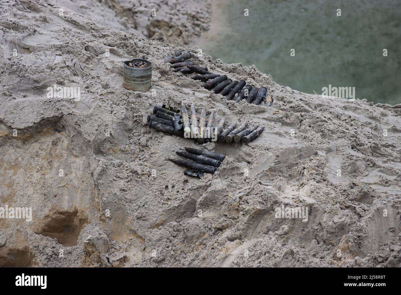 KYIV REGION, UKRAINE - APRIL 20, 2022 - Ammunition collected in the territories liberated from Russian invaders is arranged on the ground during an ex Stock Photo