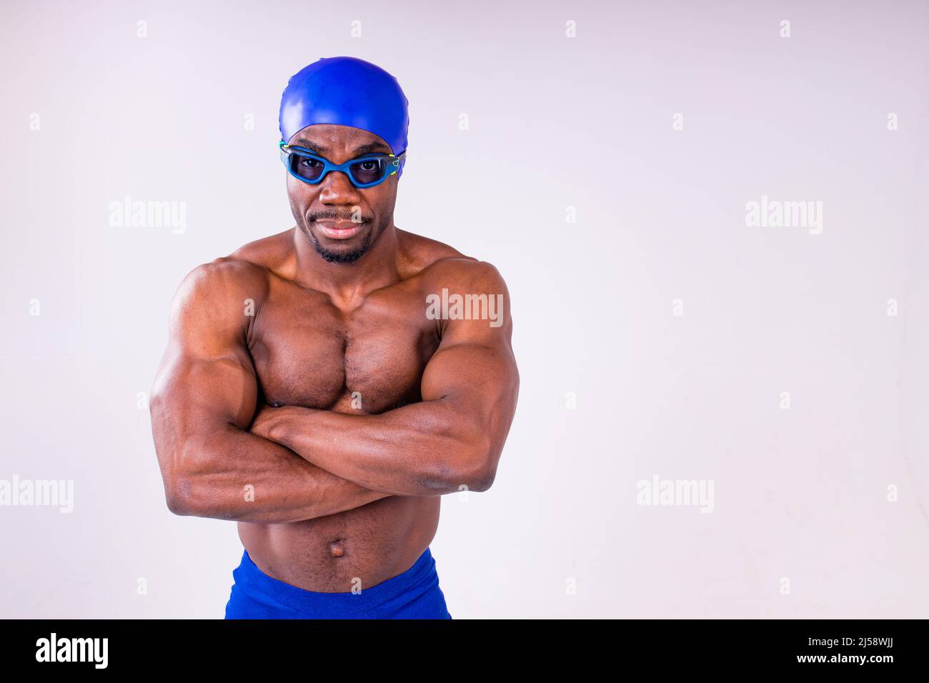 afro latin mixed race man swimmer getting ready to start swimming isolated on white background in studio Stock Photo