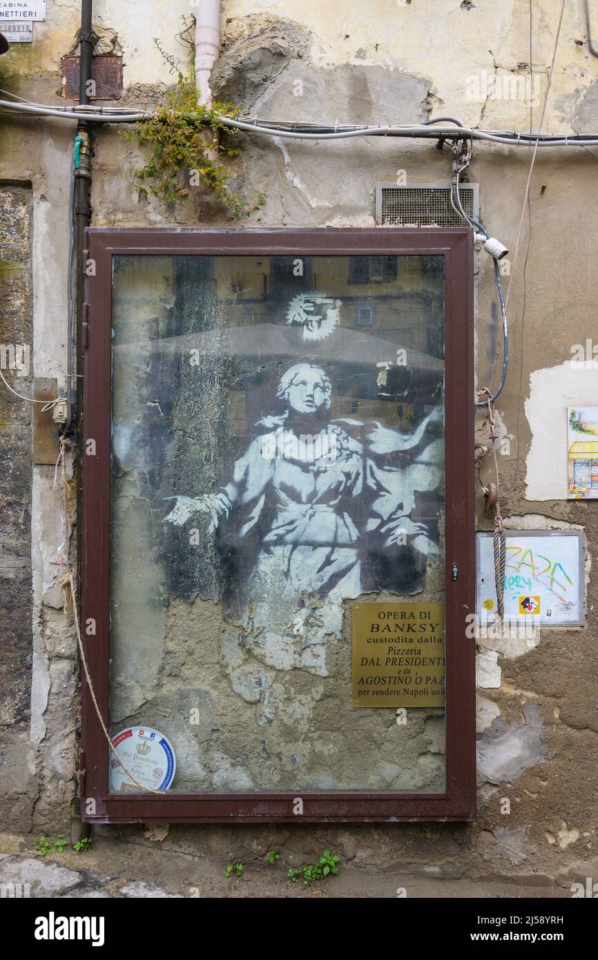 Banksy street mural of St Gennaro behind protective frame Naples Italy Stock Photo