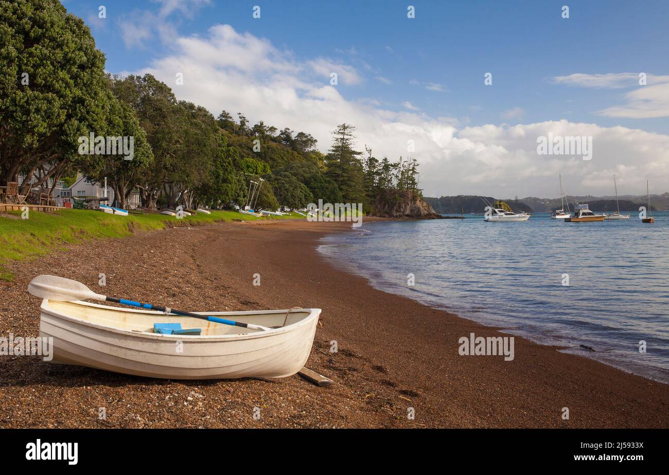 A dinghy rests on the shore in Russell, a seaside town in the Bay of