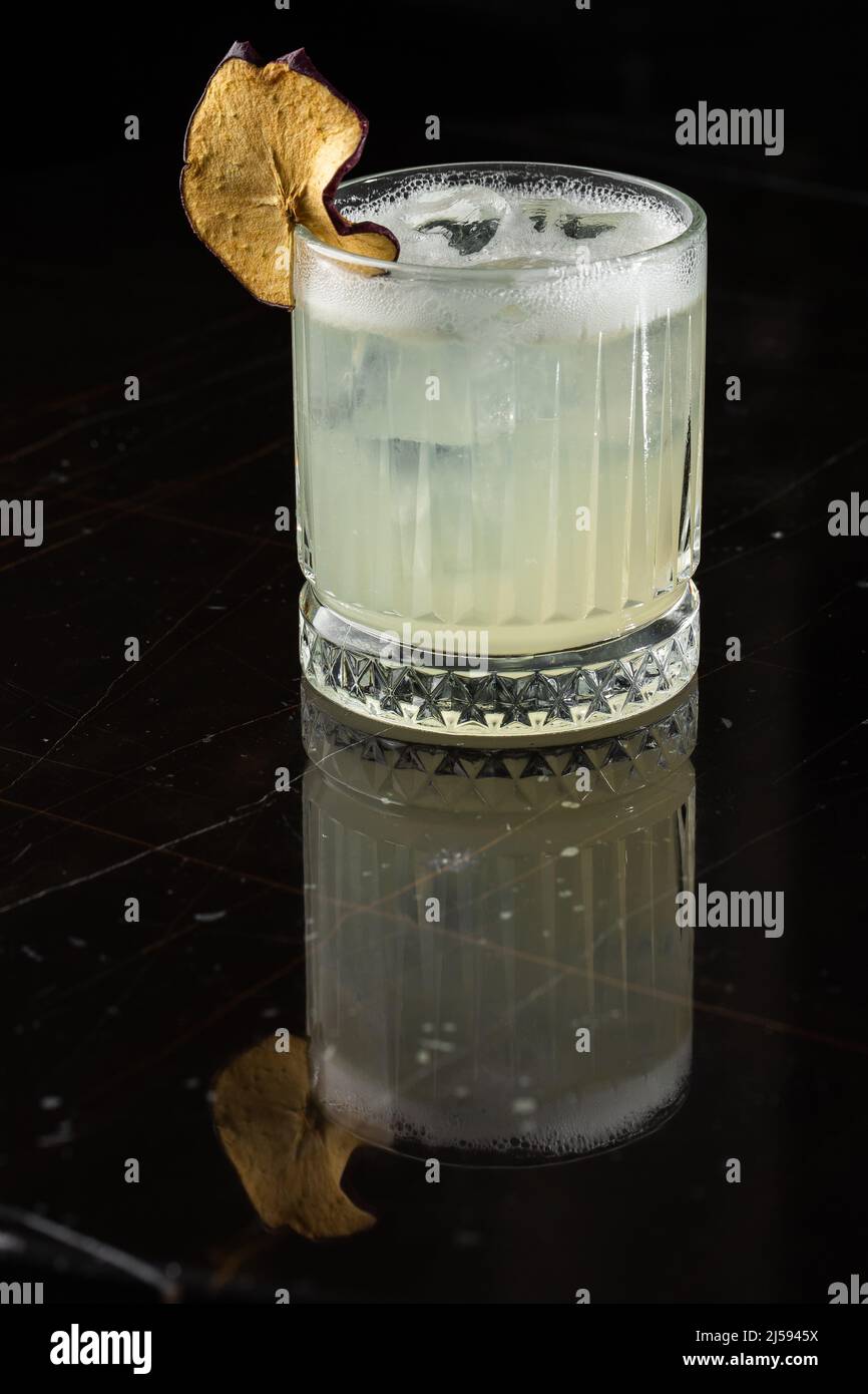 Classic cocktail glass on glass table in night club restaurant. Alcohol