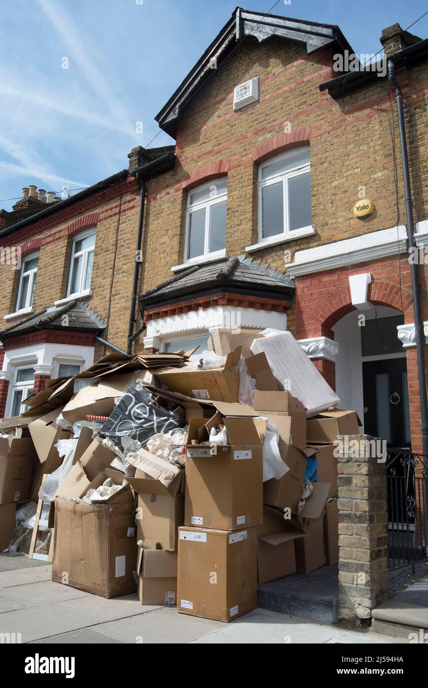 cardboard boxes filled with discarded packaging and other rubbish piled outside a mid-terrace victorian house in twickemham, middlesex, england Stock Photo