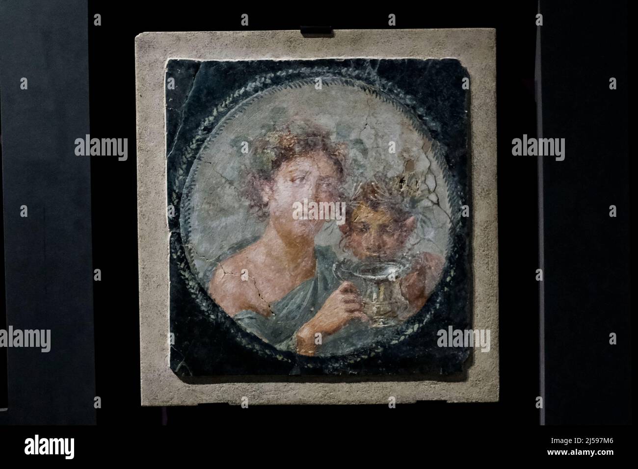 Medallion with Maenad and young Satyr holding a silver wine cup displayed at the exhibition 'Art and sensuality in the houses of Pompeii' 70 works on display, all from the storerooms of the Archaeological Park of Pompeii, Inaugurated today 21 April 2022 inside the large gymnasium Stock Photo
