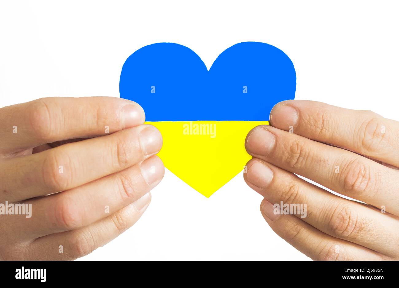 Love Ukraine concept. Hands in the shape of a heart are painted in the color of the flag of Ukraine - yellow and blue. Selective focus. Independence D Stock Photo