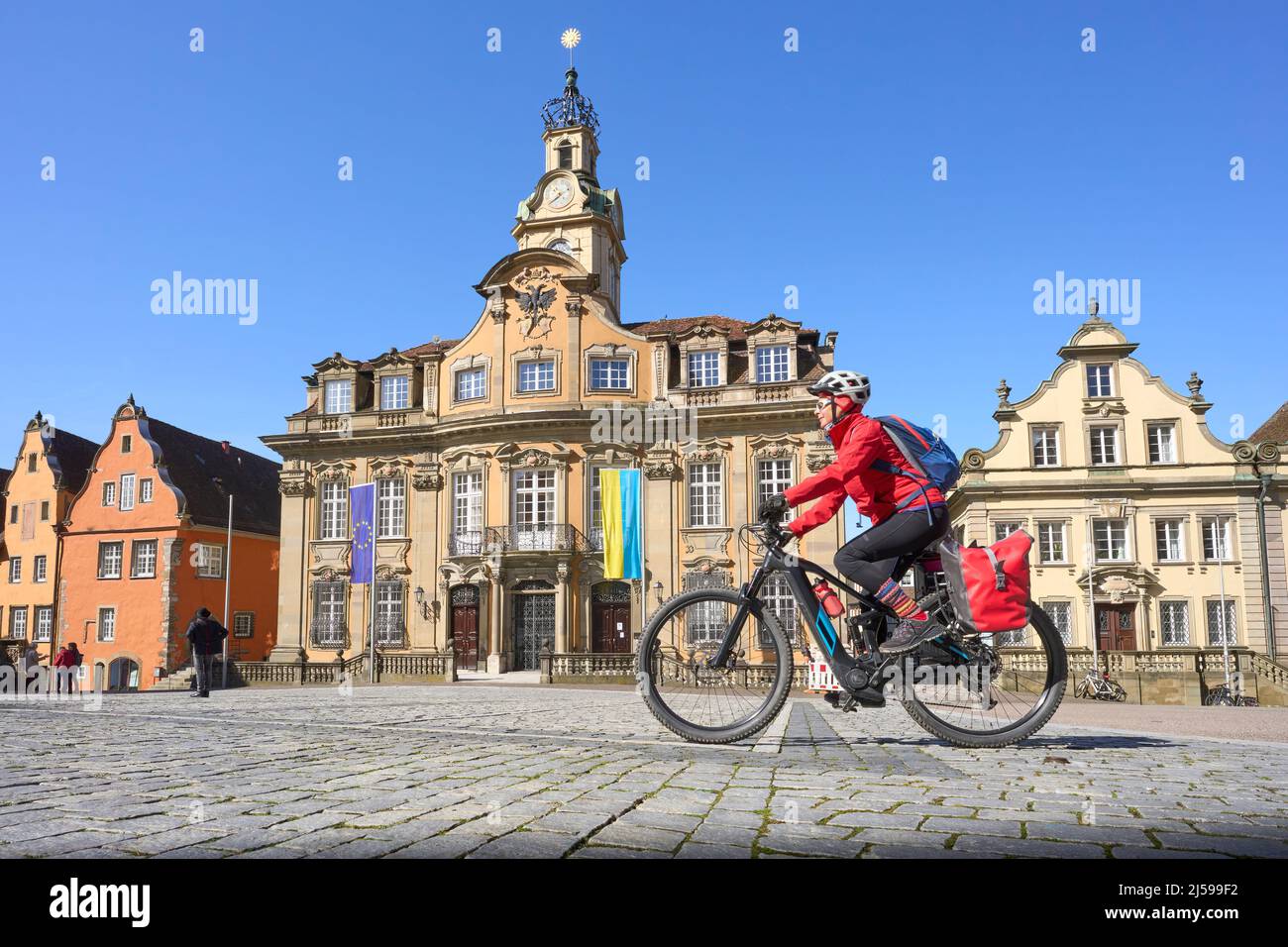 woman on bicycle tour in downtown of Schwaebisch Hall, one of the most famous  medieval cities in Baden-Wuerttemberg, Germany Stock Photo