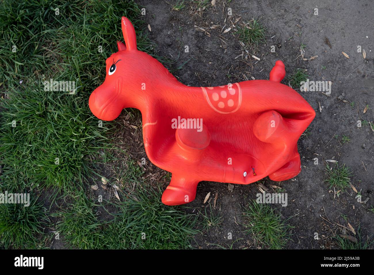 An inflatable child's toy lies discarded on the ground in Ruskin Park, a south London green space in Lambeth, on 21st April 2022, in London, England. Stock Photo