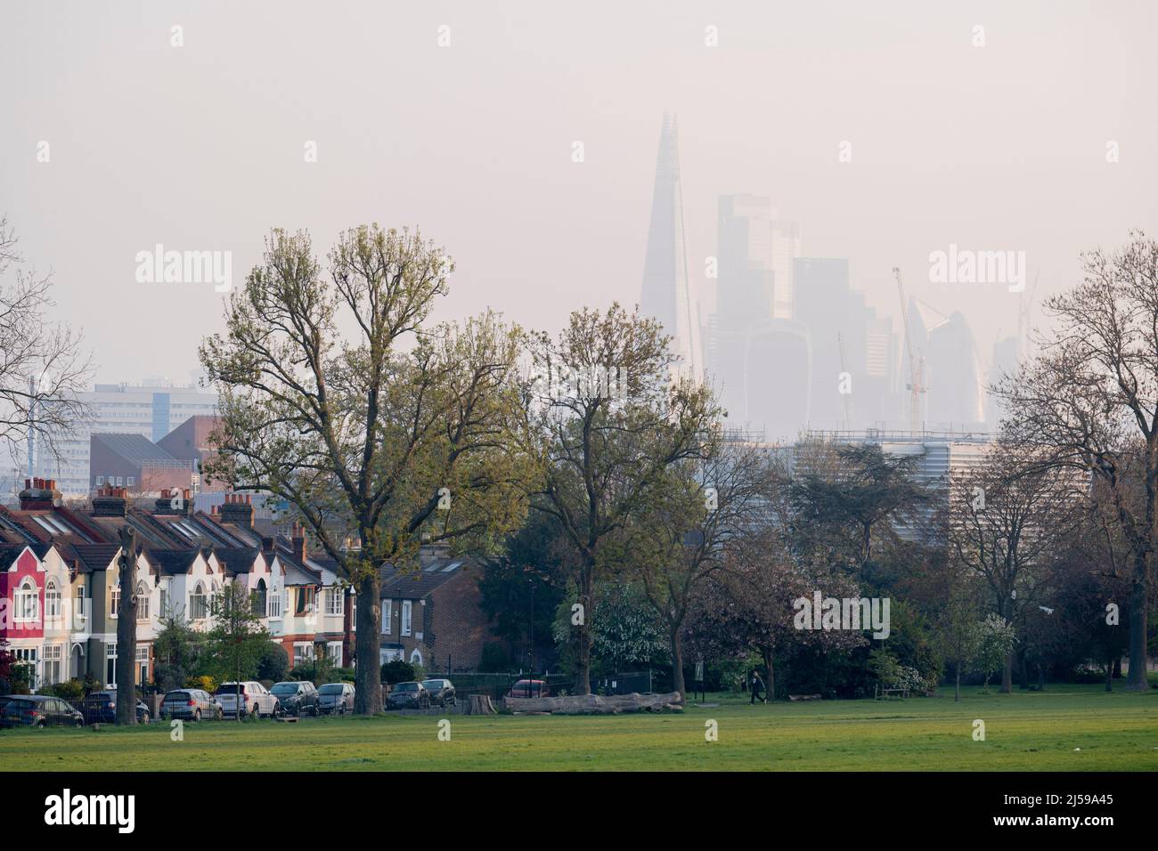 South London properties and the Shard, seen from Ruskin Park, a south London green space in Lambeth, on 21st April 2022, in London, England. Stock Photo