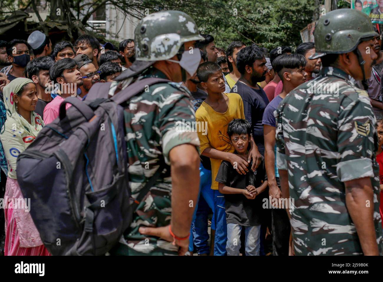 New Delhi, India. 20th Apr, 2022. Police stands by as residents watch the demolition of illegal construction in the high-tension area that witnessed communal violence between two groups during a Hanuman Jayanti procession, in New Delhi's Northwest Jahangirpuri neighborhood, India. (Photo by Amarjeet Kumar Singh/SOPA Images/Sipa USA) Credit: Sipa USA/Alamy Live News Stock Photo