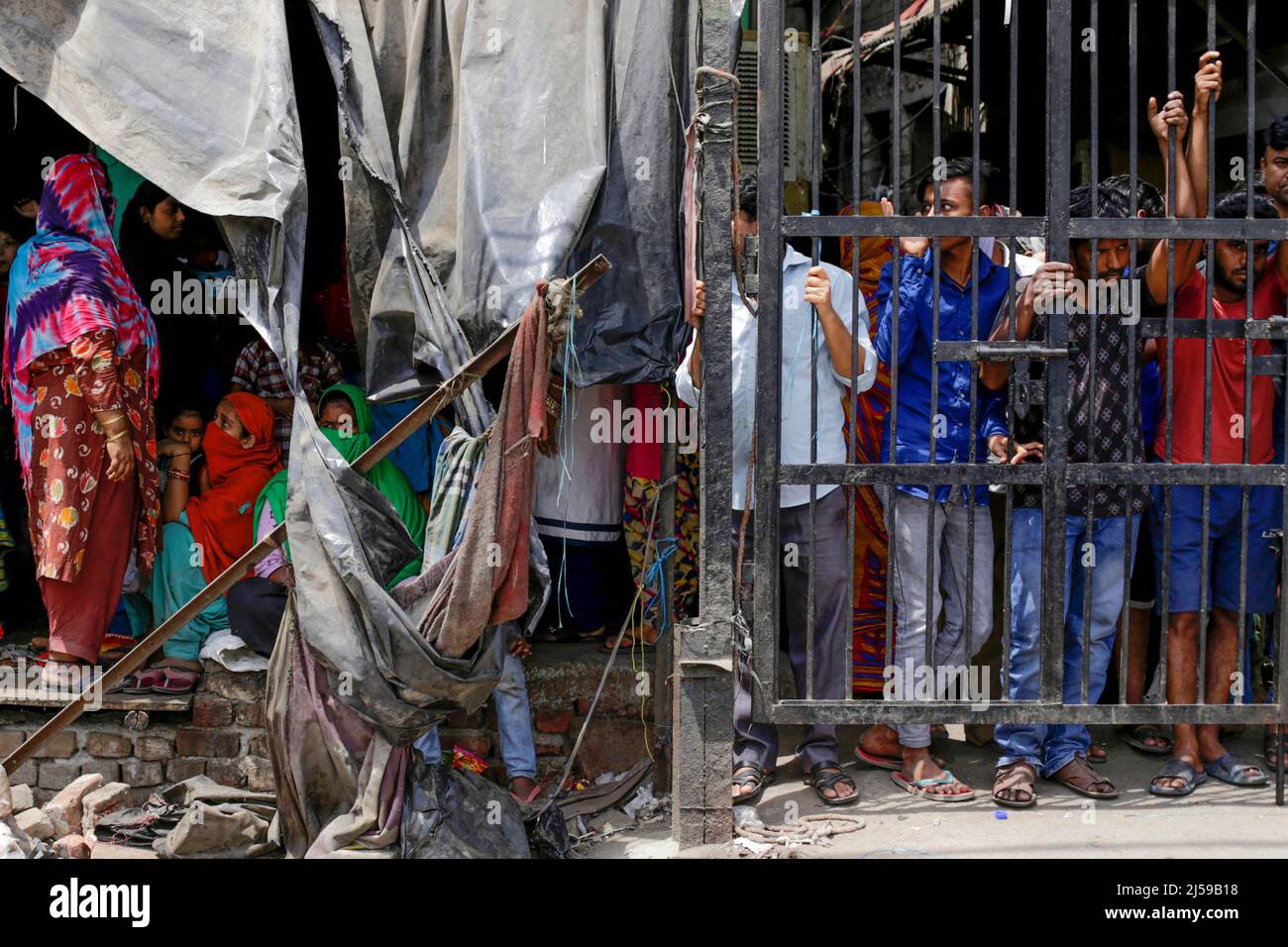 New Delhi, India. 20th Apr, 2022. Residents are watching the demolition of illegal construction in the high-tension area that witnessed communal violence between two groups during a Hanuman Jayanti procession, in New Delhi's Northwest Jahangirpuri neighborhood, India. (Photo by Amarjeet Kumar Singh/SOPA Images/Sipa USA) Credit: Sipa USA/Alamy Live News Stock Photo