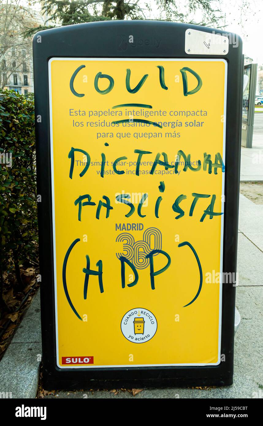 COVID fascist distance, in Spanish - vandalised bus stop stand in Madrid, Spain Stock Photo