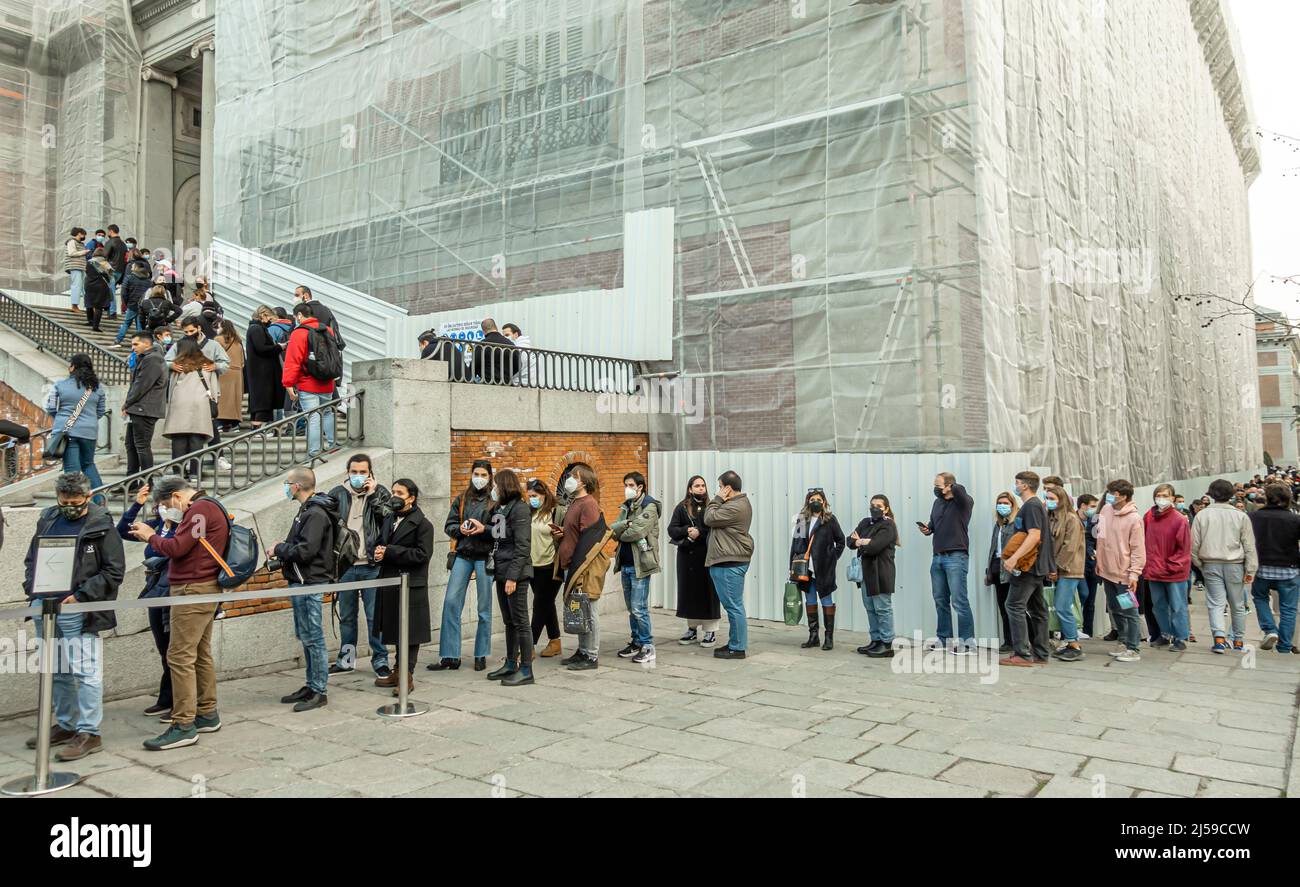 A long line of tourists people queued up to enter the Prado Museum. Madrid, Spain Stock Photo