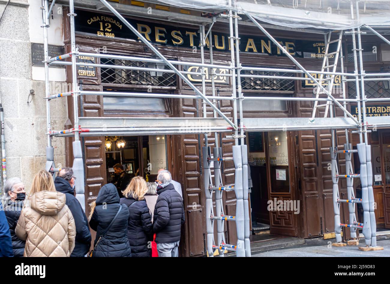 Historic restaurant Casa Labra under scaffolding with a line queue of ...